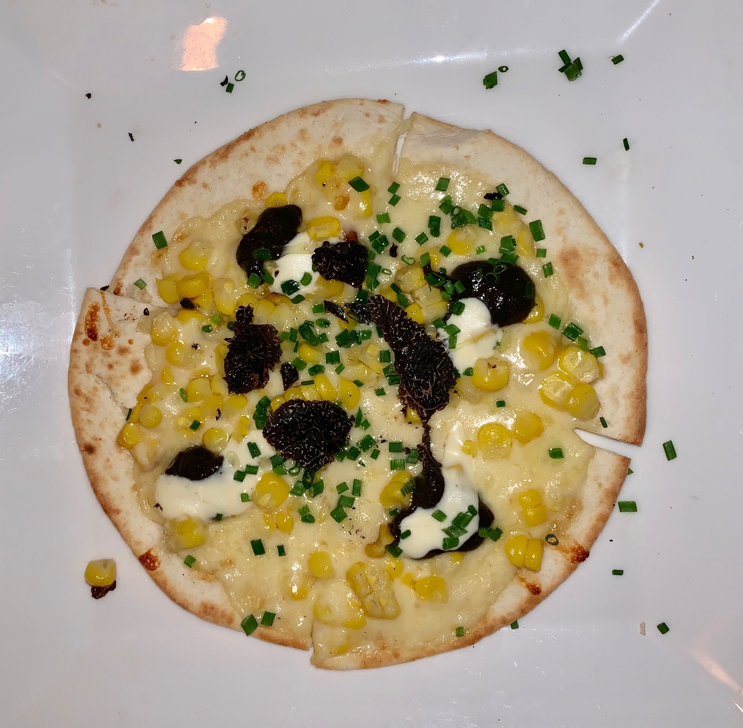 Thin-crusted truffle and huitlacoche pizza at Toloache.