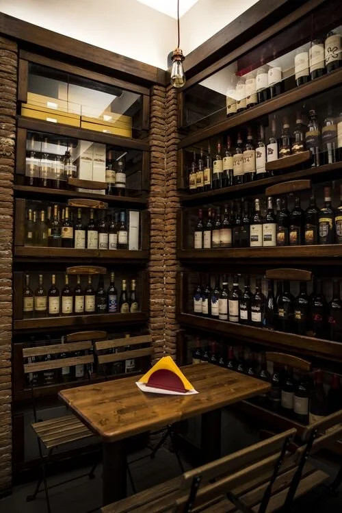 wine bottles line the walls at Enoteca Belledonne.
