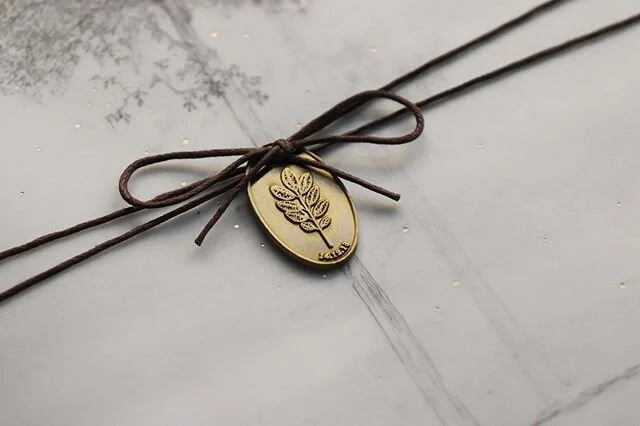 Working closely with our special bride and the inspiring collection of curated images and thoughts that she shared with us, we designed an aesthetic that alludes to foggy forests, collected emblems, and lavish textures.

This was done by layering ill