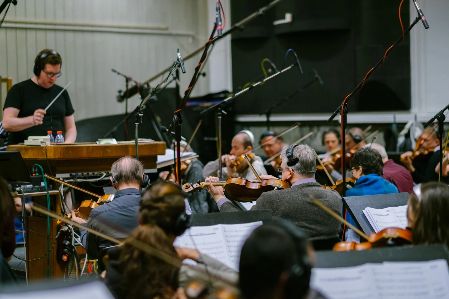 Evan conducting an orchestra in the recording studio