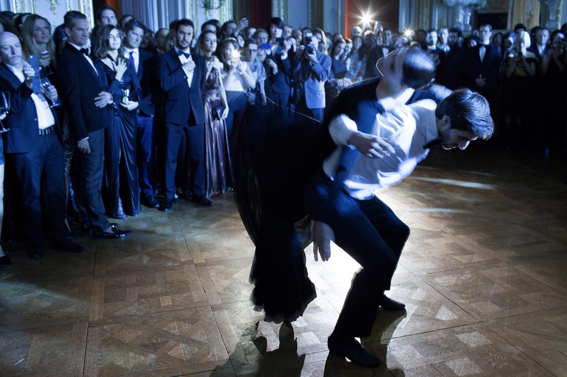   Scene from a black tie ball in Paris, with a dance performed by Marie Agnes Gillot.   