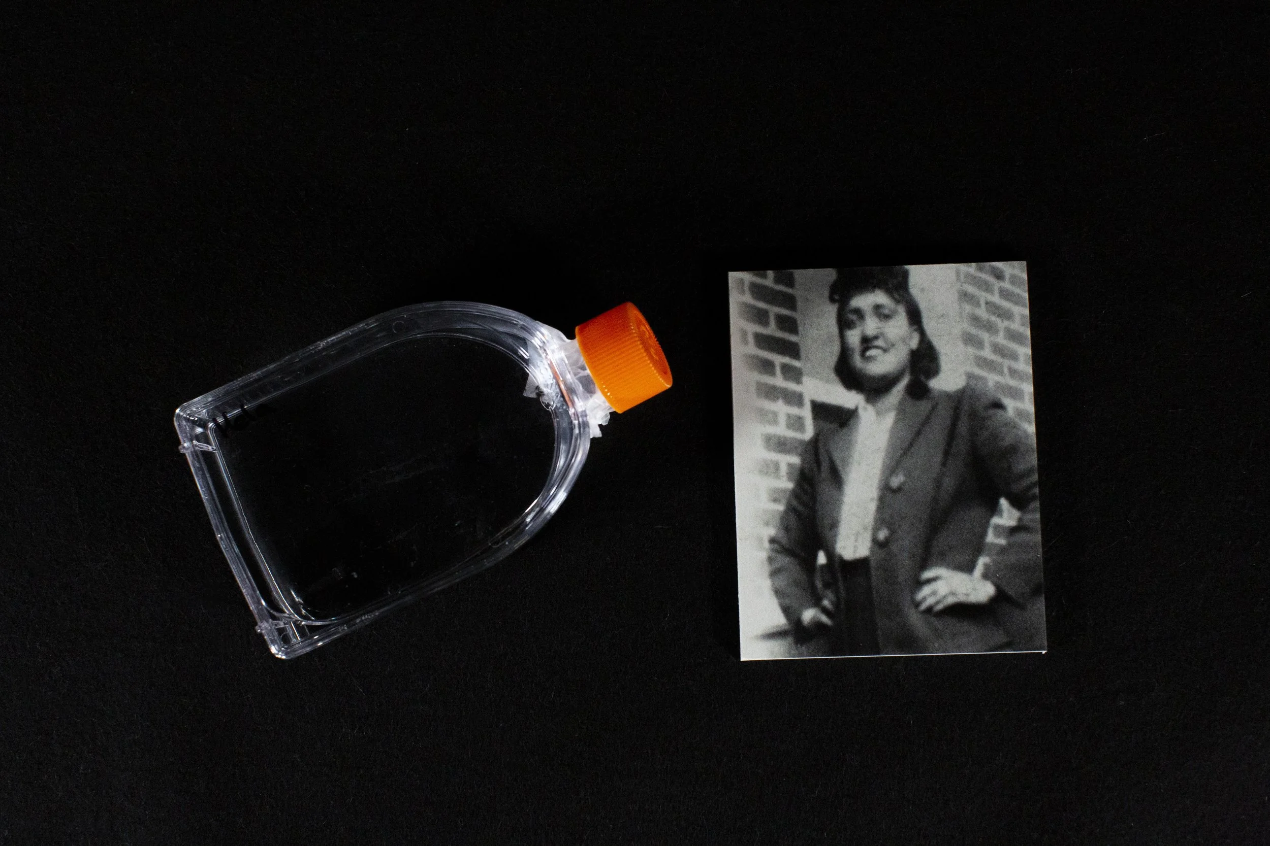A culture flask with “HeLa” cells taken from Henrietta Lacks, right, who died of cervical cancer in the 1950s.