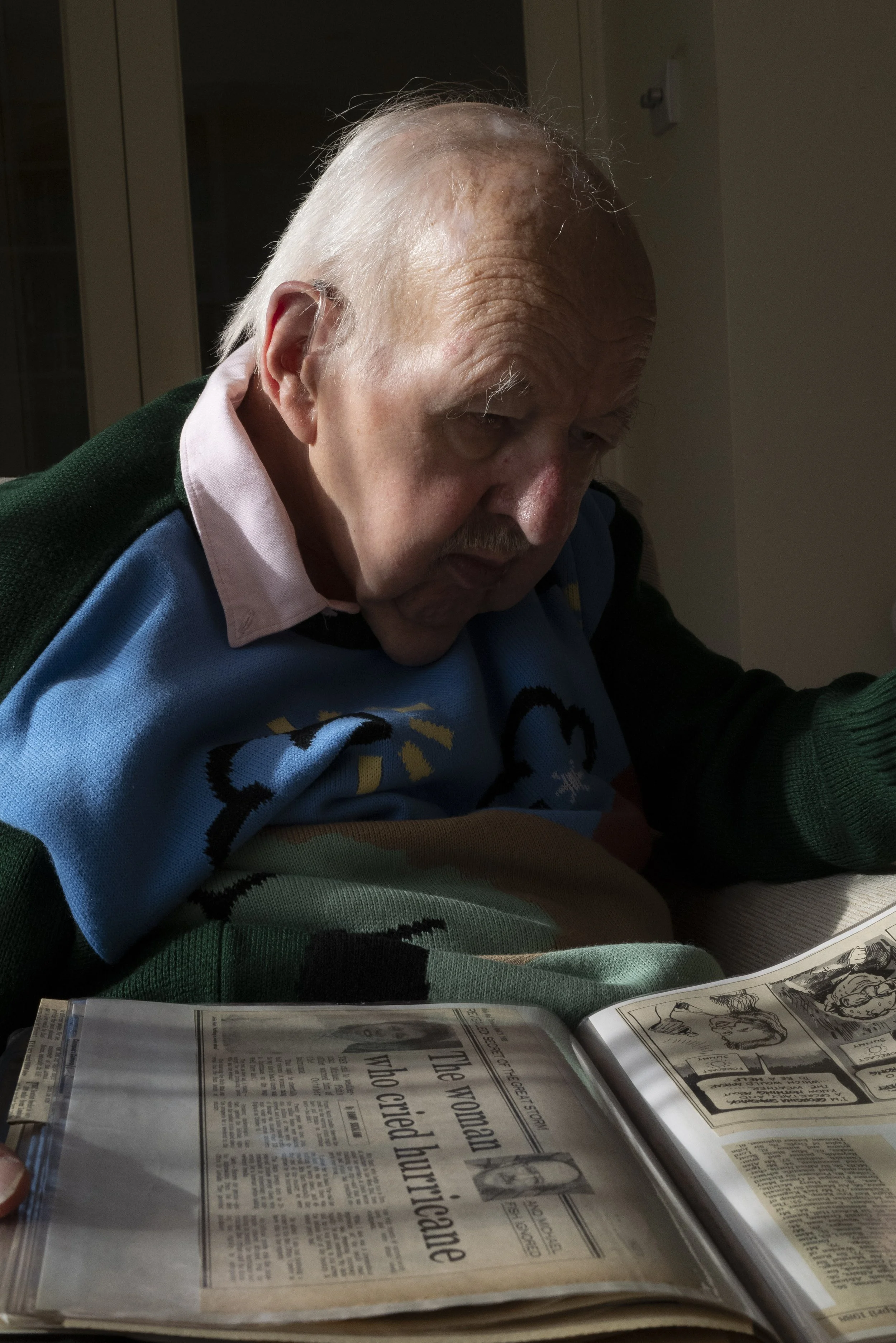  Michael Fish, the famous BBC weatherman whose forecast for the Great Storm of 1987 became infamous. He is photographed at home with his scrapbook of news clippings related to the storm and his career. The devastation of the storm prompted a complete