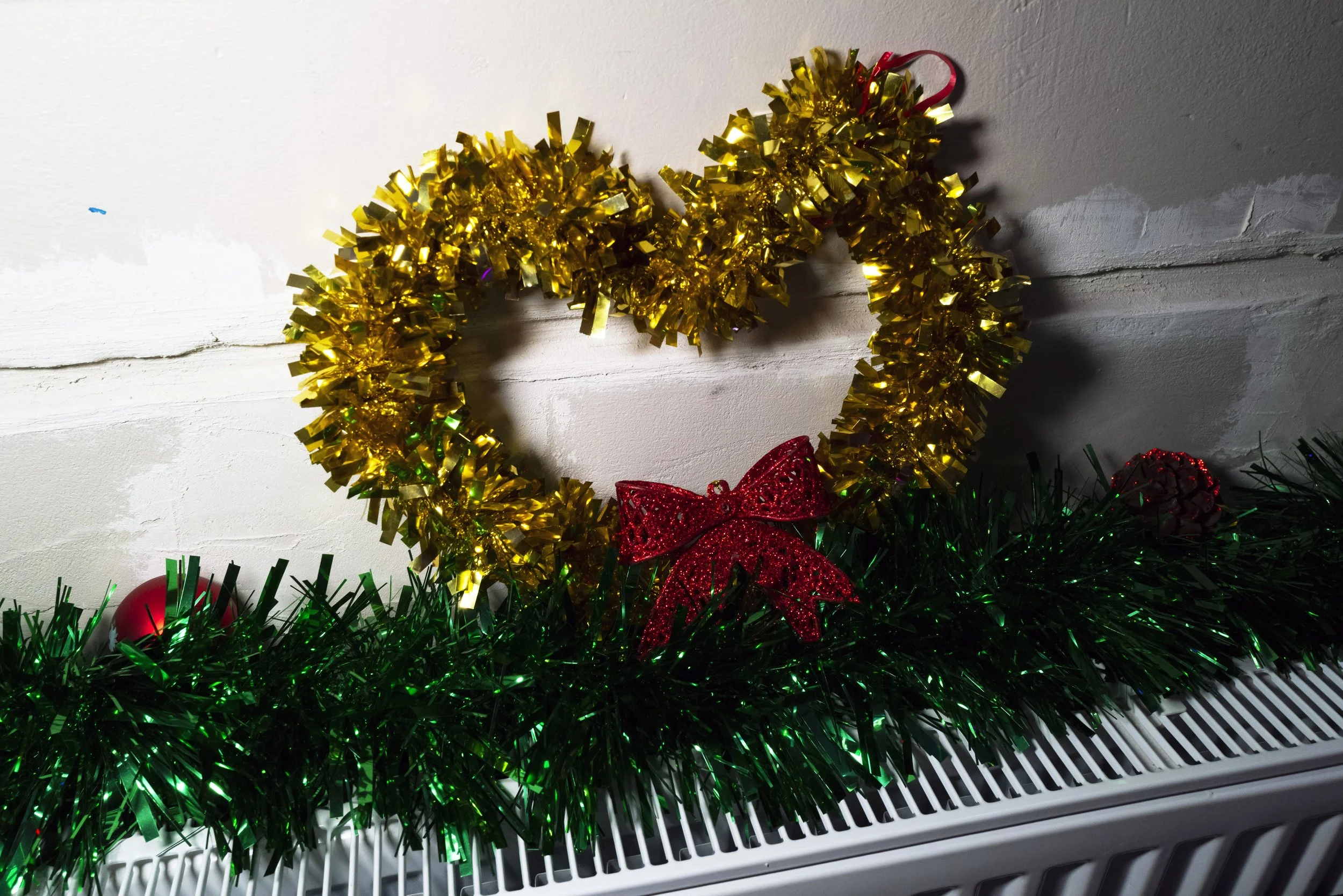  A heart-shaped tinsel decoration on a heater inside the hall of a Hackney church decorated for The Posh Club, a social club for older adults that transformed the community space with festive décor for an afternoon of live performances, dancing and s