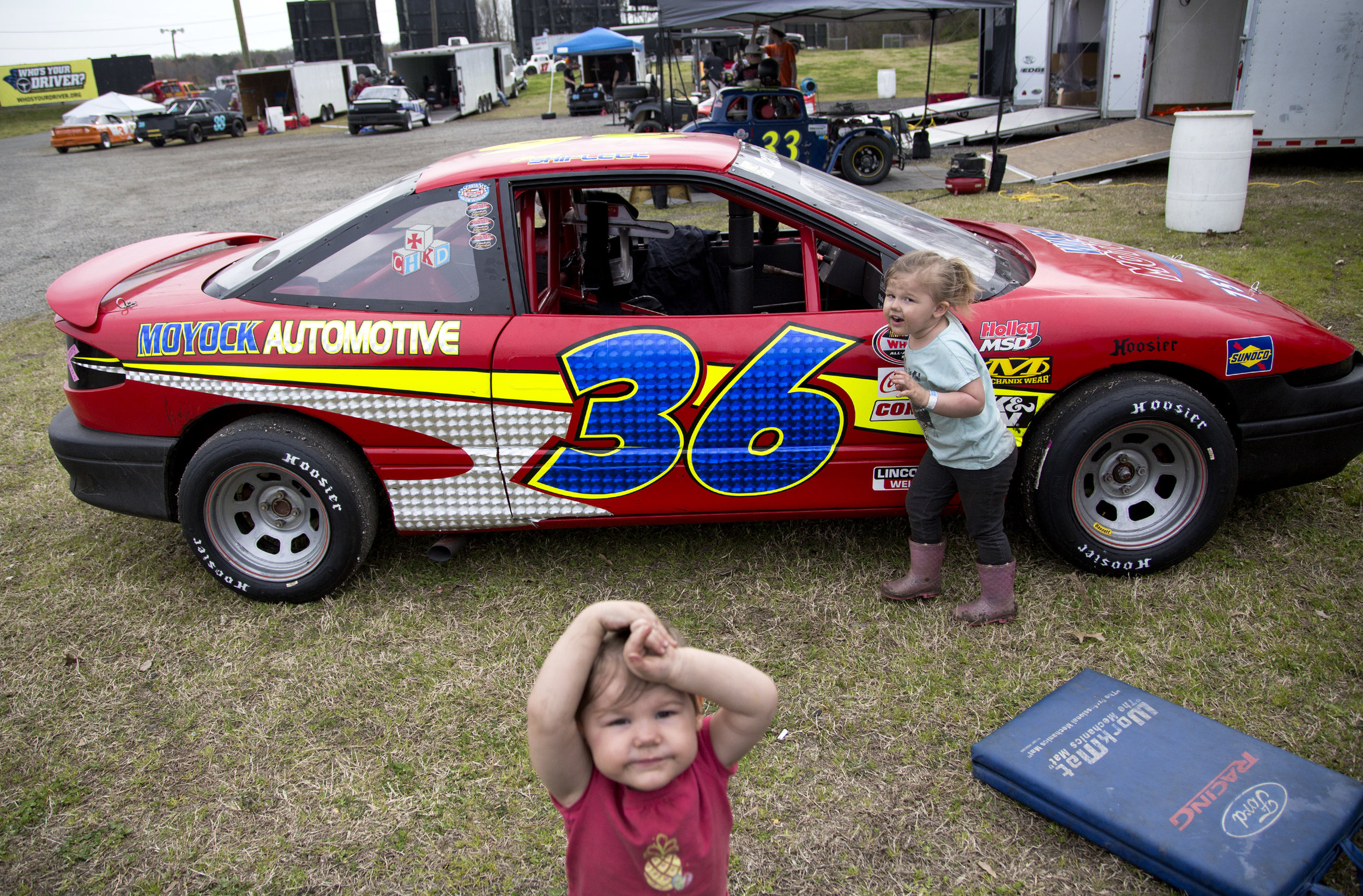  Sisters Kinsley, 2, and Adalynn Waters, 3, play in front of their mom's Ucar before the opening night races at Langley Speedway in Newport News, VA, on March 30, 2019. 