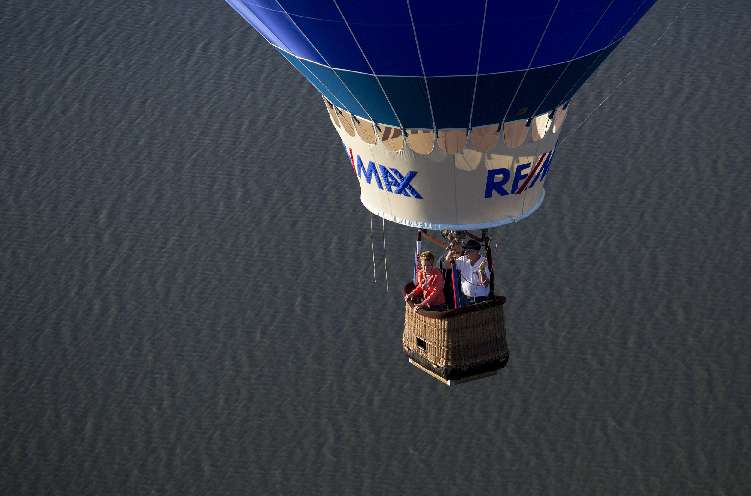  Pilot, Reed Basley, in white, with passengers Dianna and JR Keen fly in the RE/MAX balloon over Smithfield on June 4, 2019. 