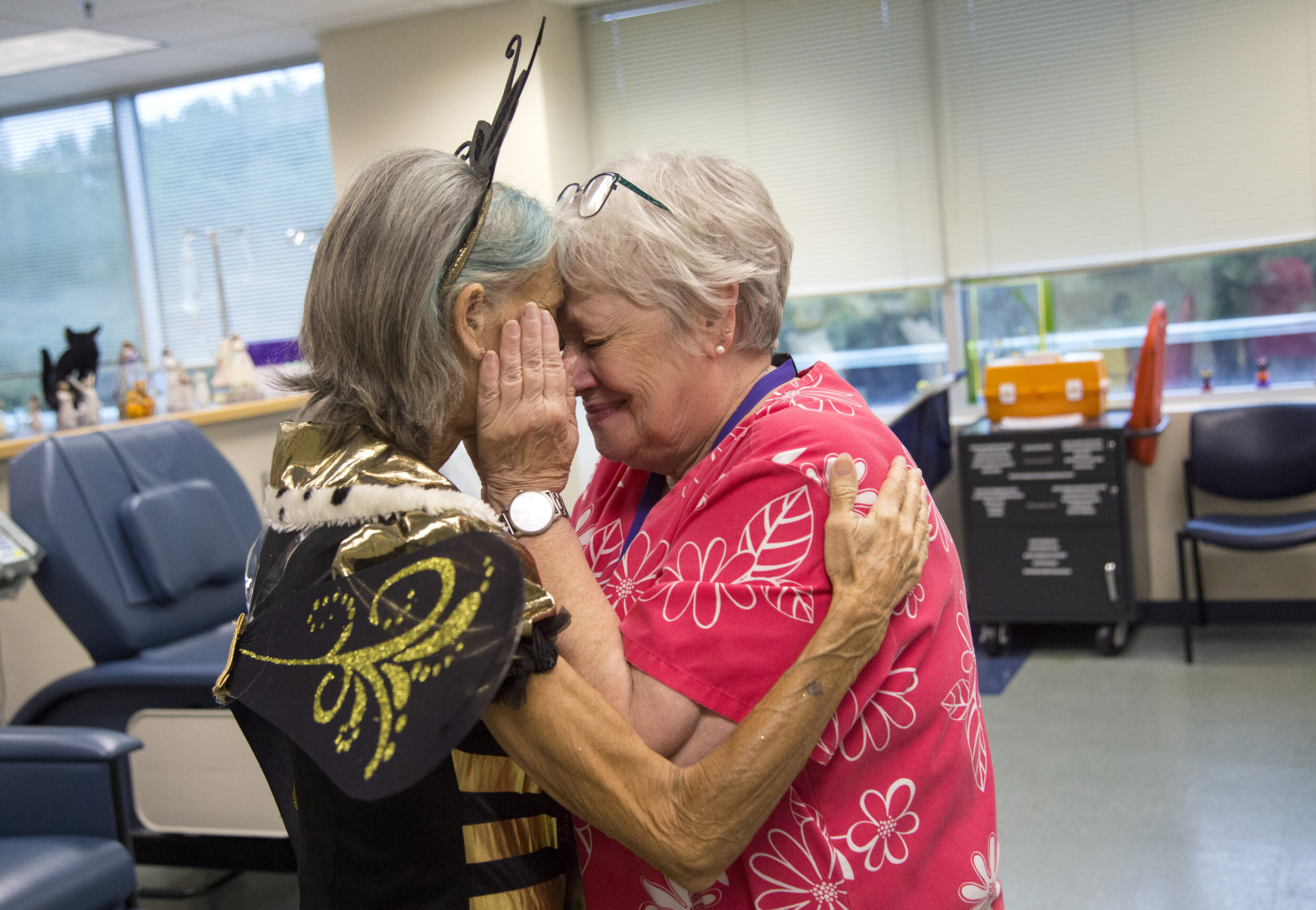  Mary Stommel, dressed as a "Queen B", says "see you later" and thanks to her nurse, Jan Jinright, at her doctor's office at Virginia Oncology Associates in Norfolk, VA, on October 8, 2019. To uplift herself and others, Mary would dress in various co