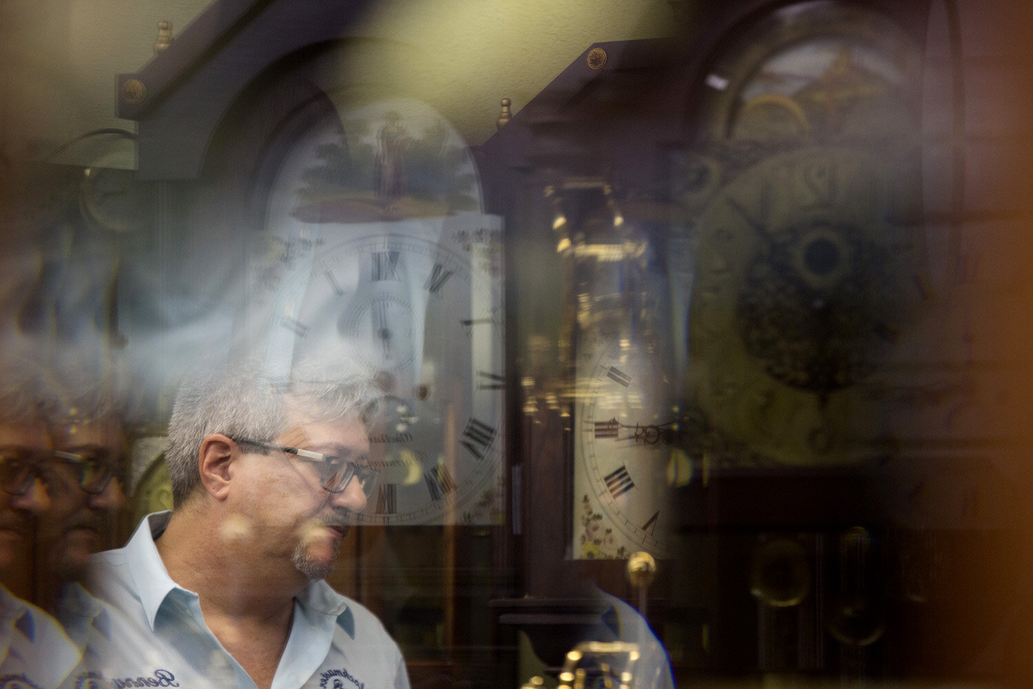  Benny Daidone, owner and master craftsman of Clockmaster of Naples, poses for a reflective portrait in his shop on July 13, 2017. Daidone has been in the clock repair industry for 32 years and recently took over this shop. 