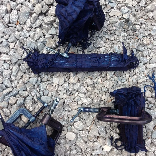 Basic block and clamping. The long stick has been wrapped and the scarf was folded on the diagonal.