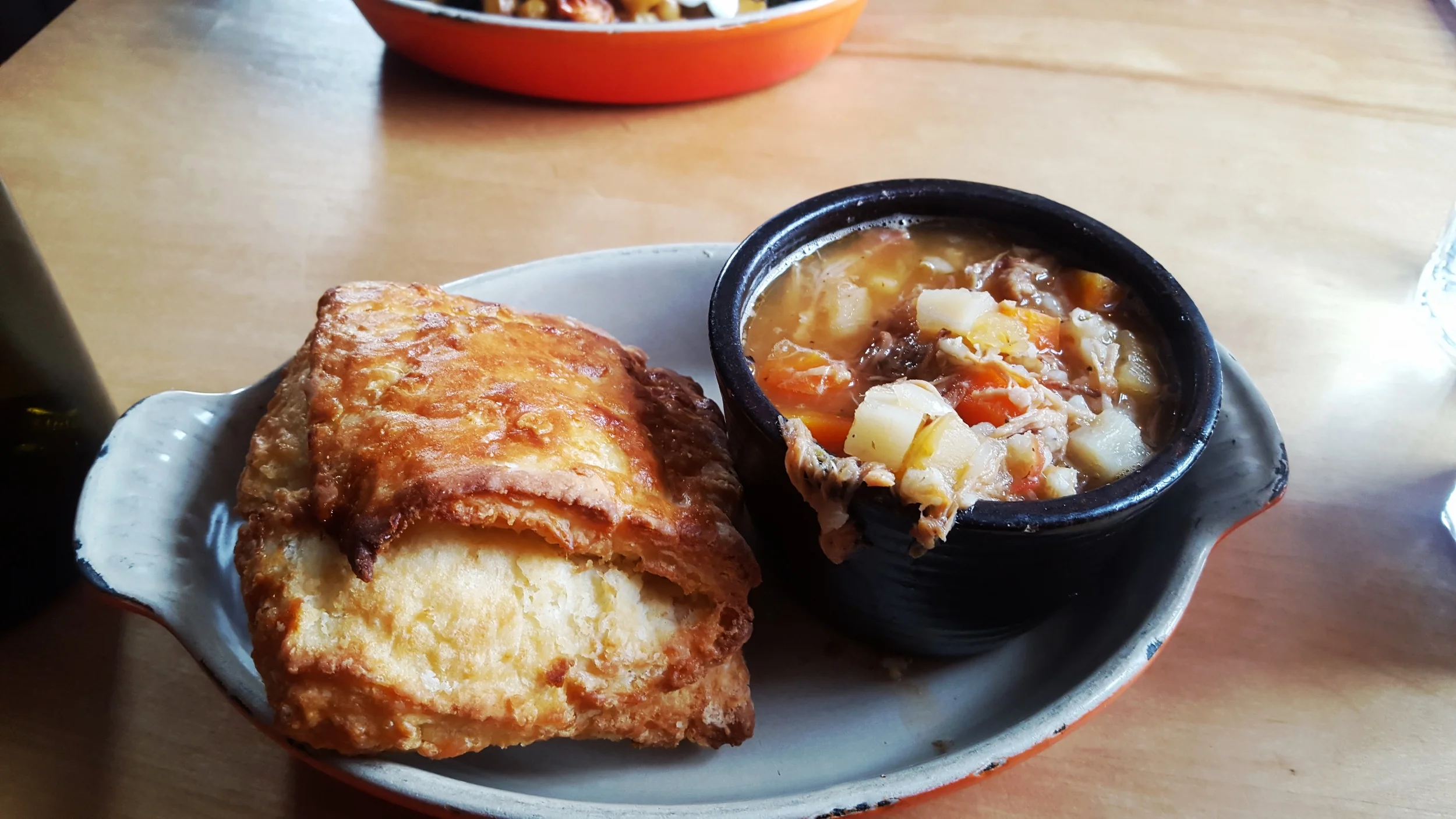 Soup Du Jour - pork cheek soup with barley and roasted root vegetables. Served with a rustic biscuit.