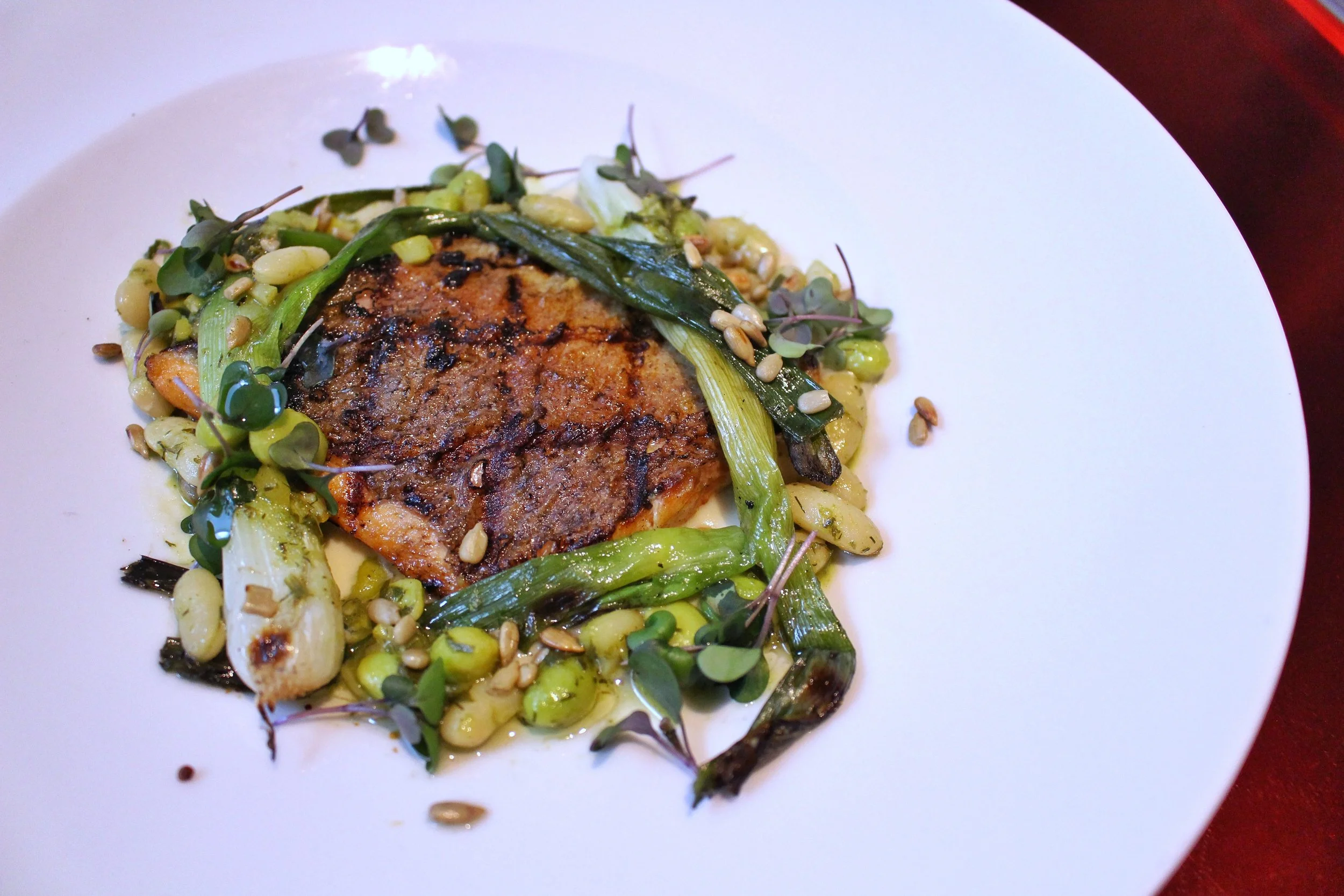 Grilled Trout - charred green onions, white bean, dill pesto, toasted sunflower seeds, artichoke and cultured cream puree