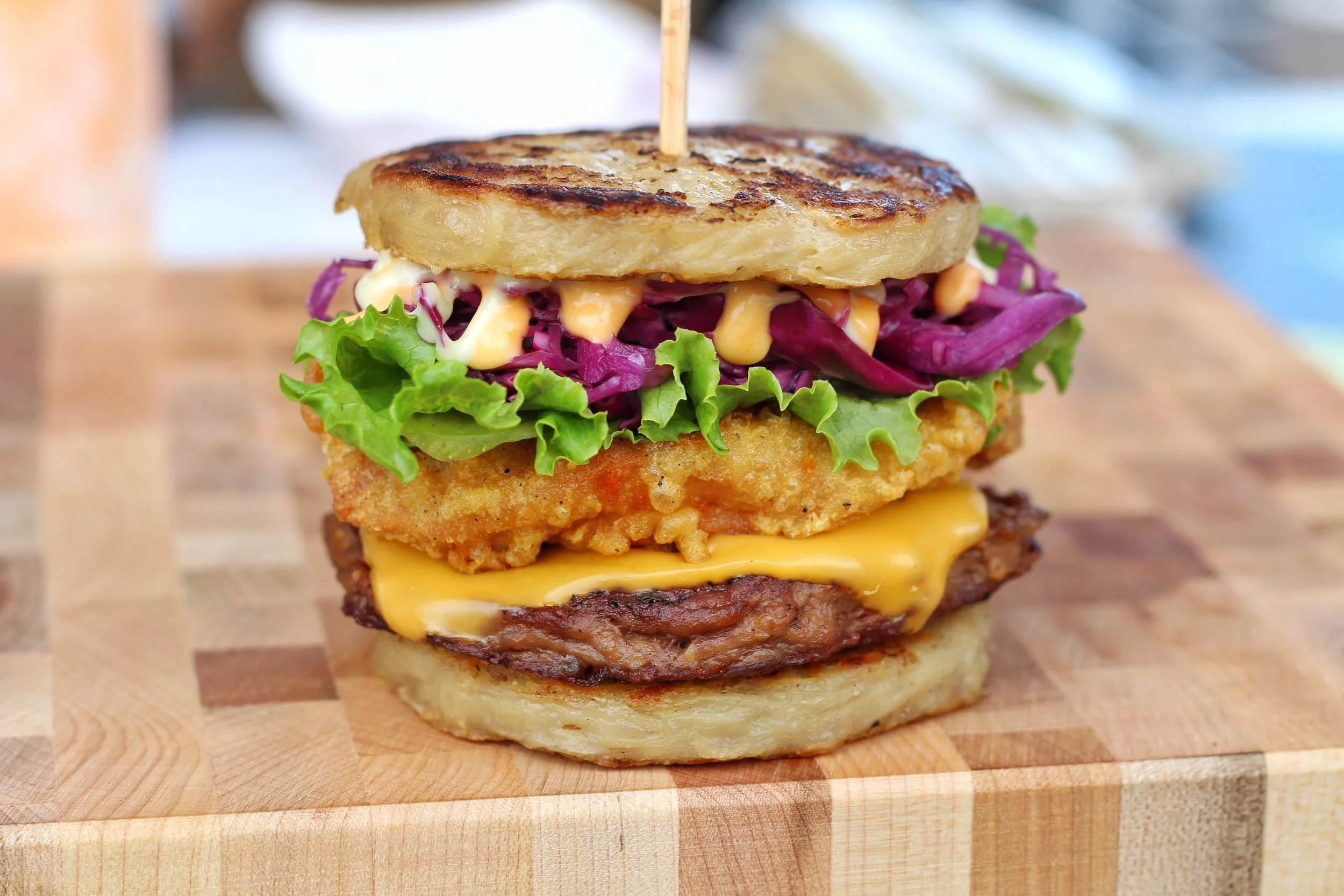 Fried chicken with a burger patty in between a ramen bun.