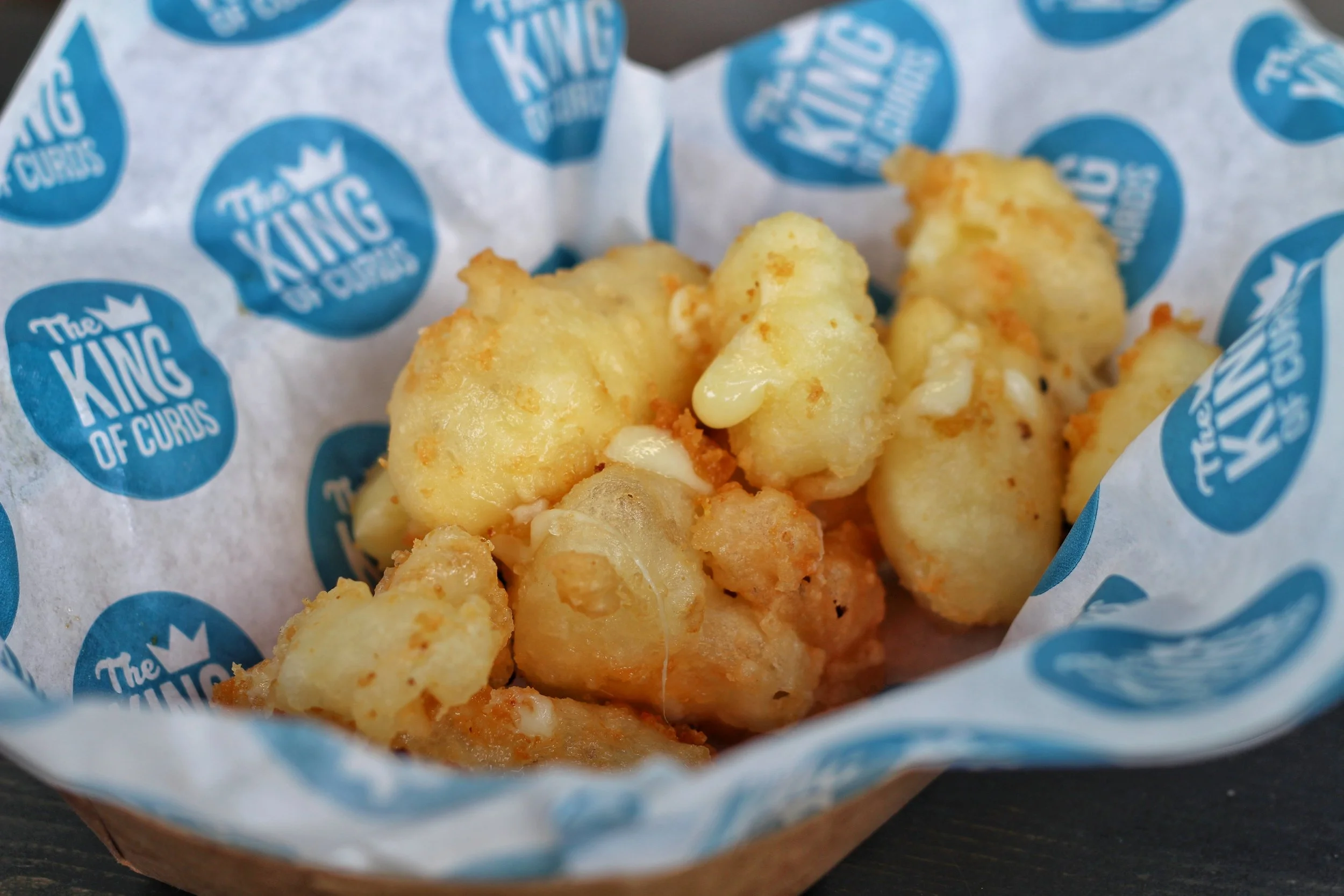 Deep fried cheese curds sprinkled with icing sugar and served with pure Canadian maple syrup.