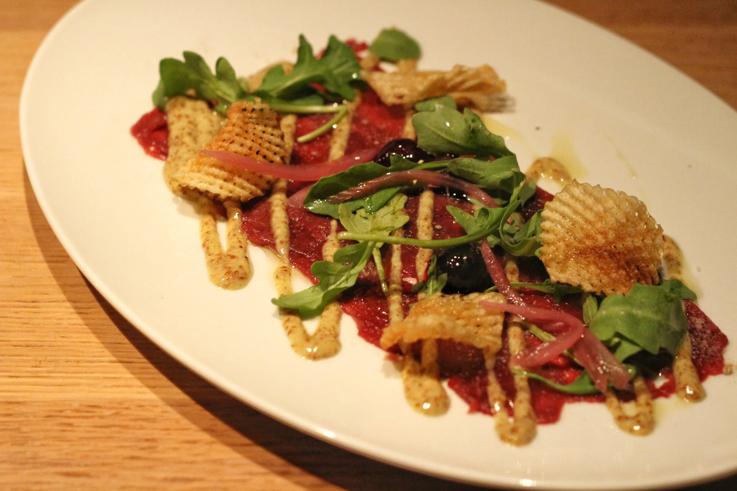 Venison Carpaccio - spiced blueberries, arugula, grainy dressing, gaufrette potato
