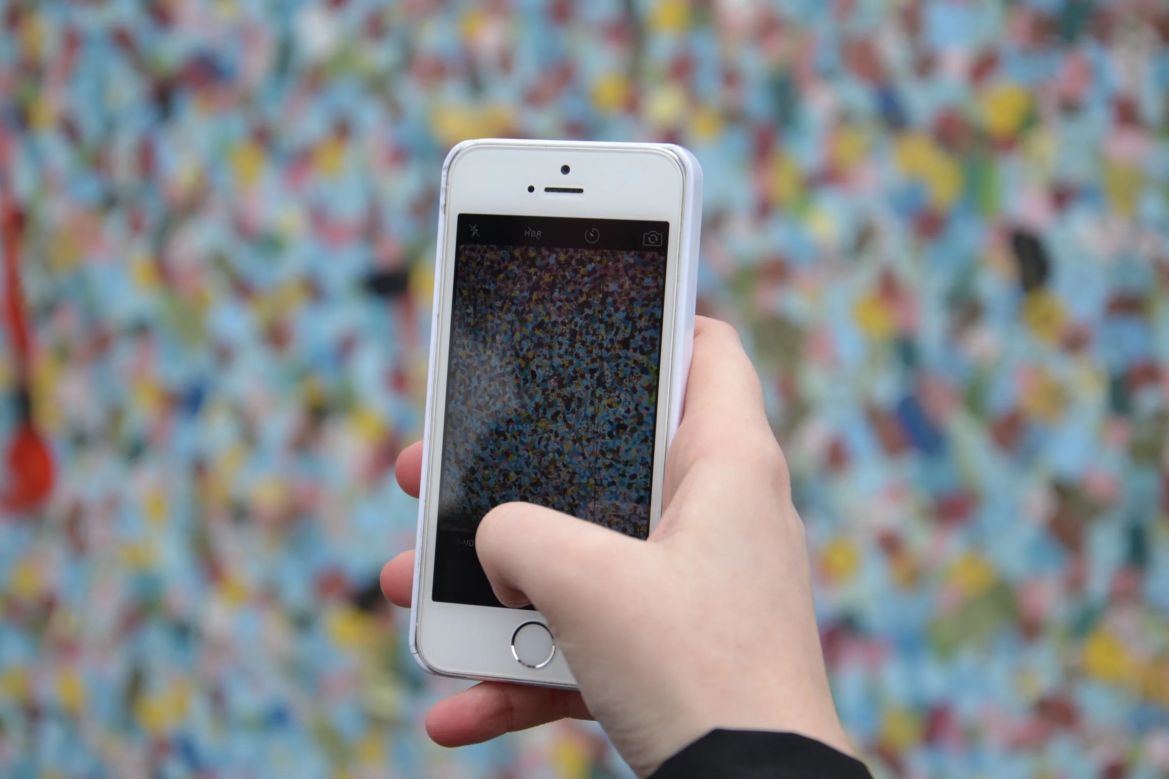 Pondering my phone obsession with a colorful wall in Germany over spring break.