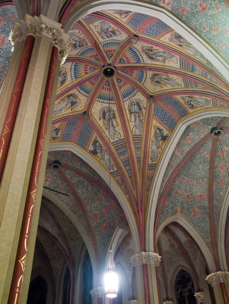 The interior features multiple apses, and richly carved wood, statues and details.