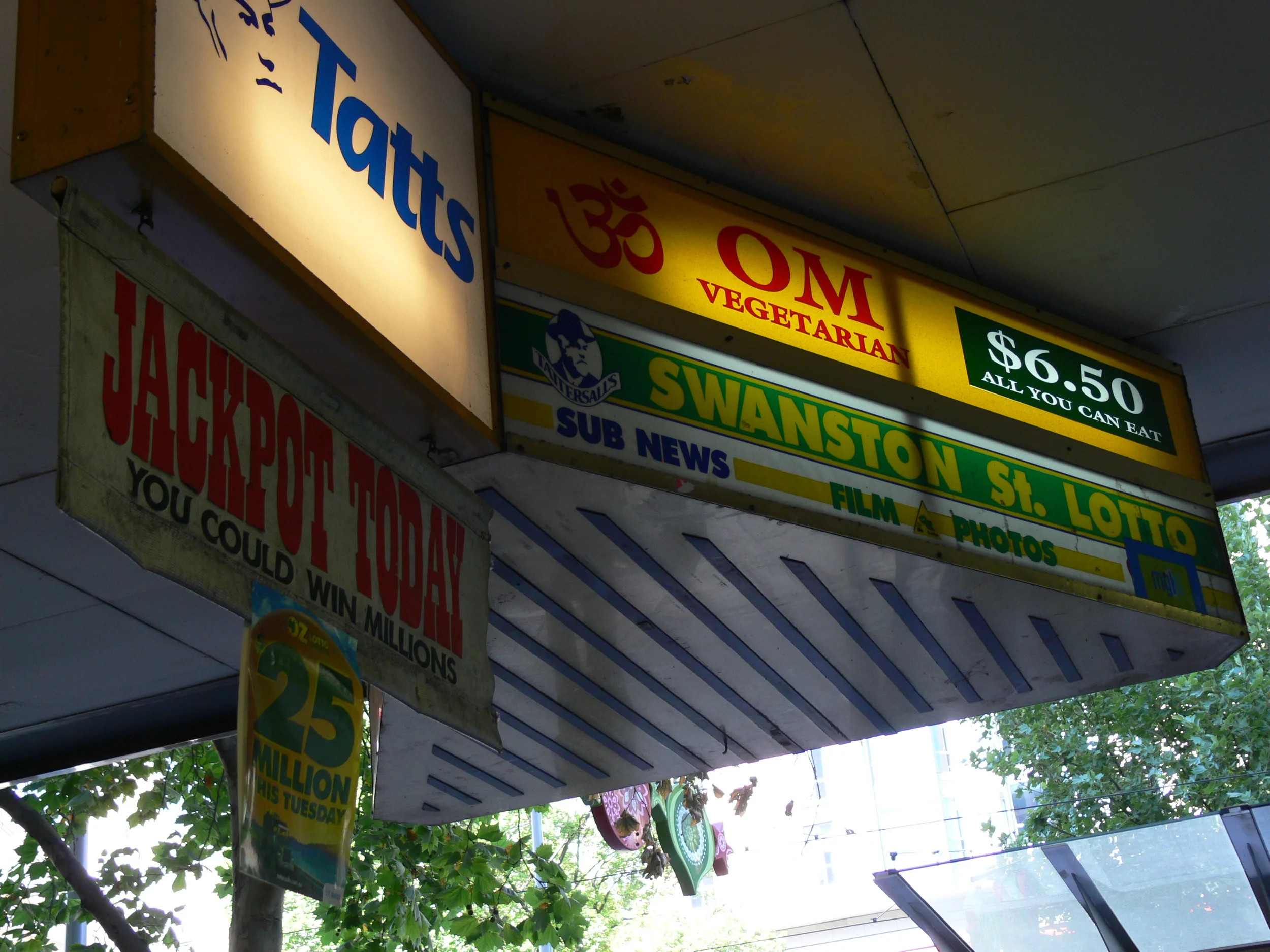 OM Vegetarian Wales Arcade Sign visible from Swanston St (opposite the tram stops)