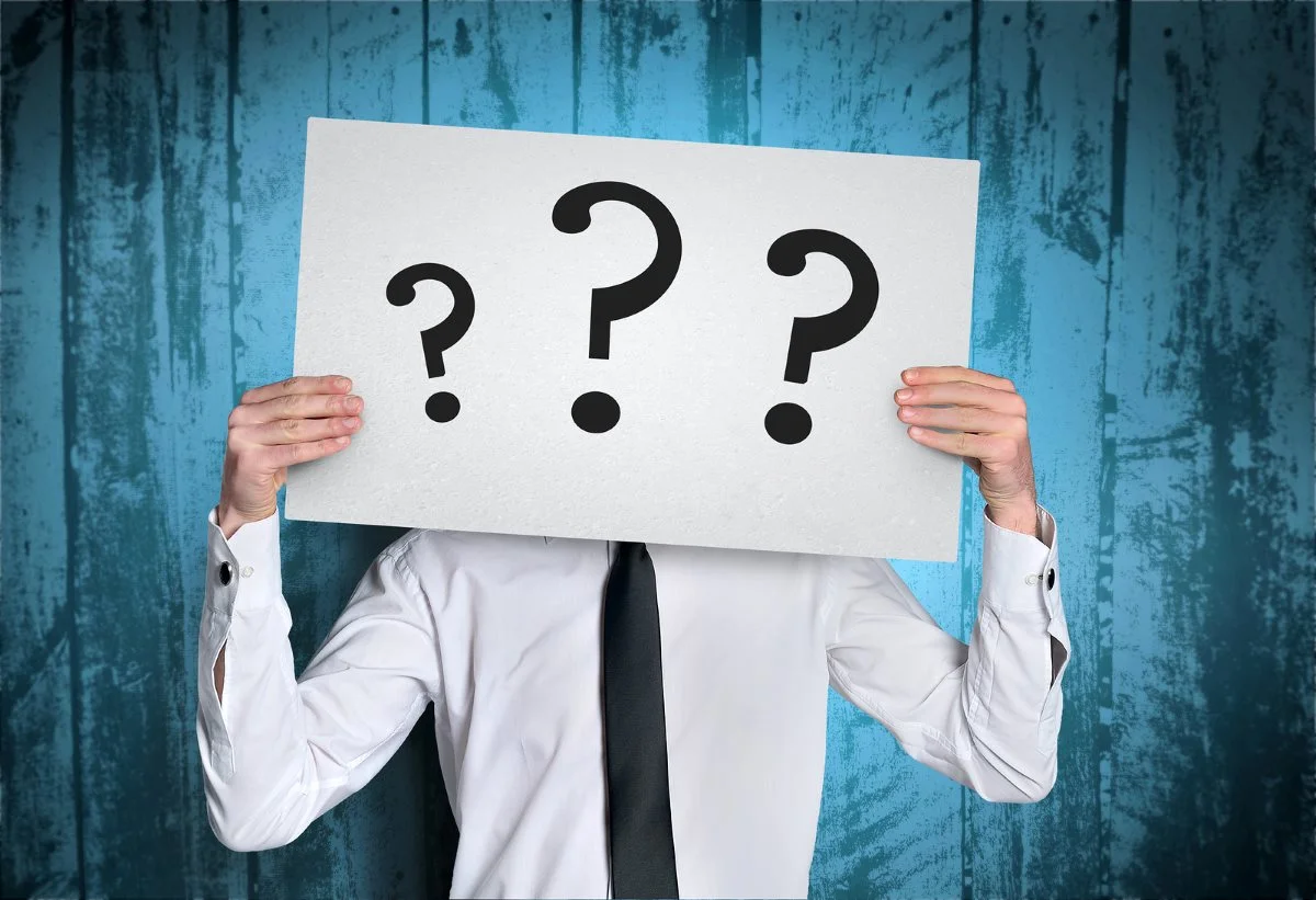 Business-man-cover-face-with-question-board.jpg