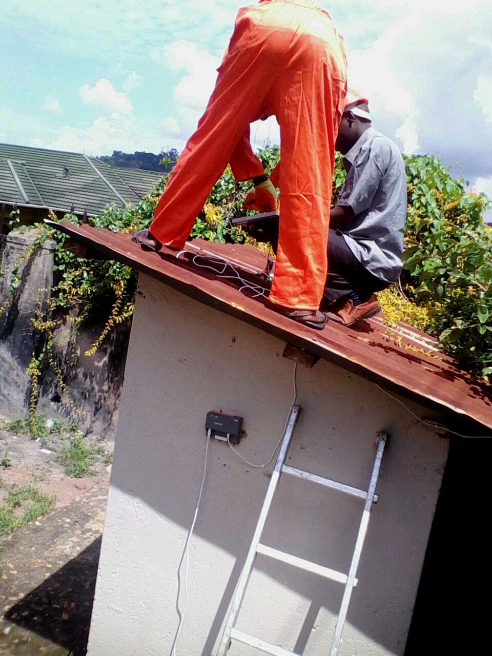 Learning soalr panel installation on the roof. At Barefoot Power..jpg