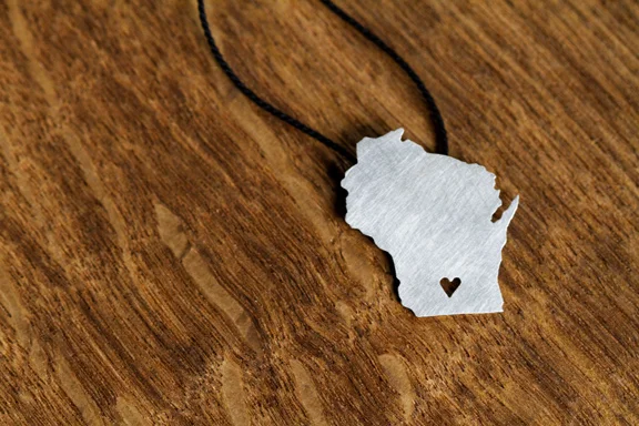 Wisconsin Shaped Silver Necklace hand-cut out of sterling silver with a cutout heart over Madison.