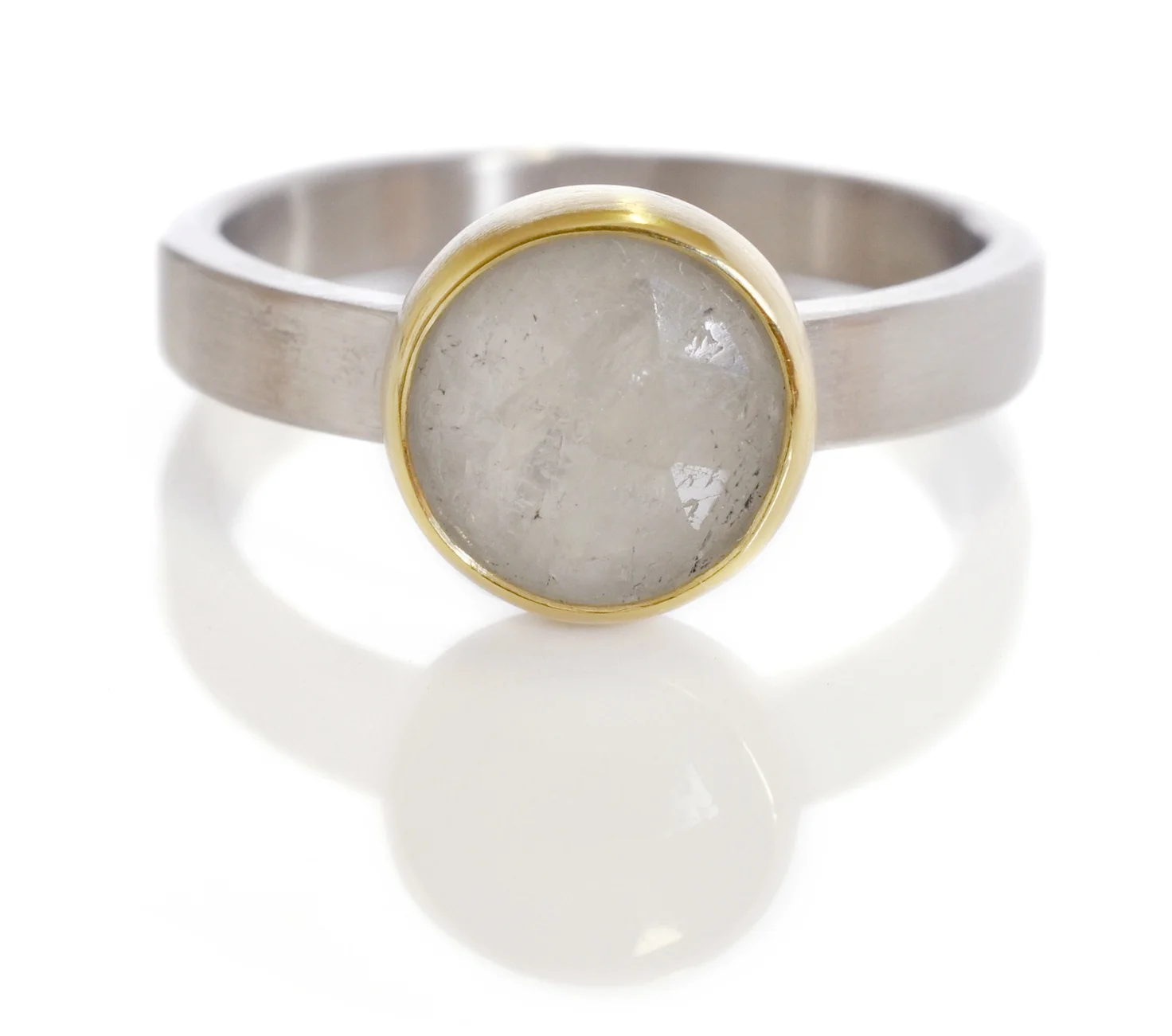 Lindsay designed a gorgeous solitaire ring with a 1.92ct white rosecut sapphire. The Sapphire was set in an 18k yellow gold bezel on a 3x1.5mm 500 palladium band with a satin finish.