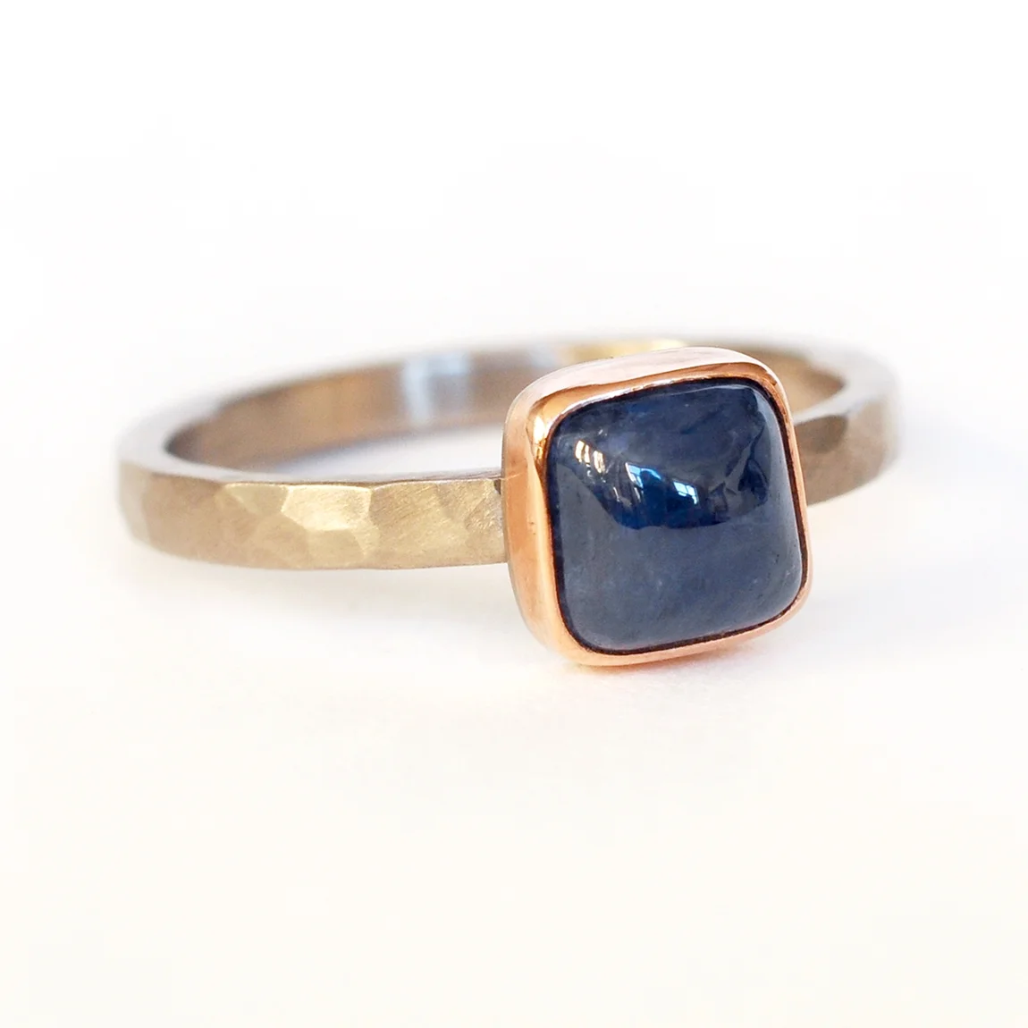 square cabachon blue sapphire solitaire 14k red rose pink bezel hammered palladium engagement ring recycled metal mixed metal conflict free stones handmade minneapolis alternative minnesota jeweler