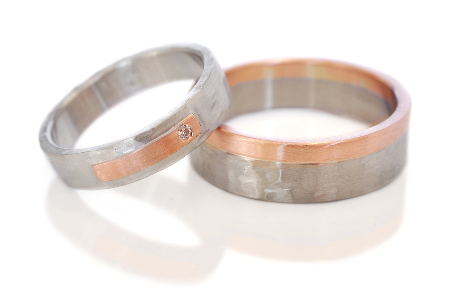 Nick and Katie chose coordinating mixed metal wedding bands with out being too matchy. Palladium and 14k red gold with the random hammered finish.