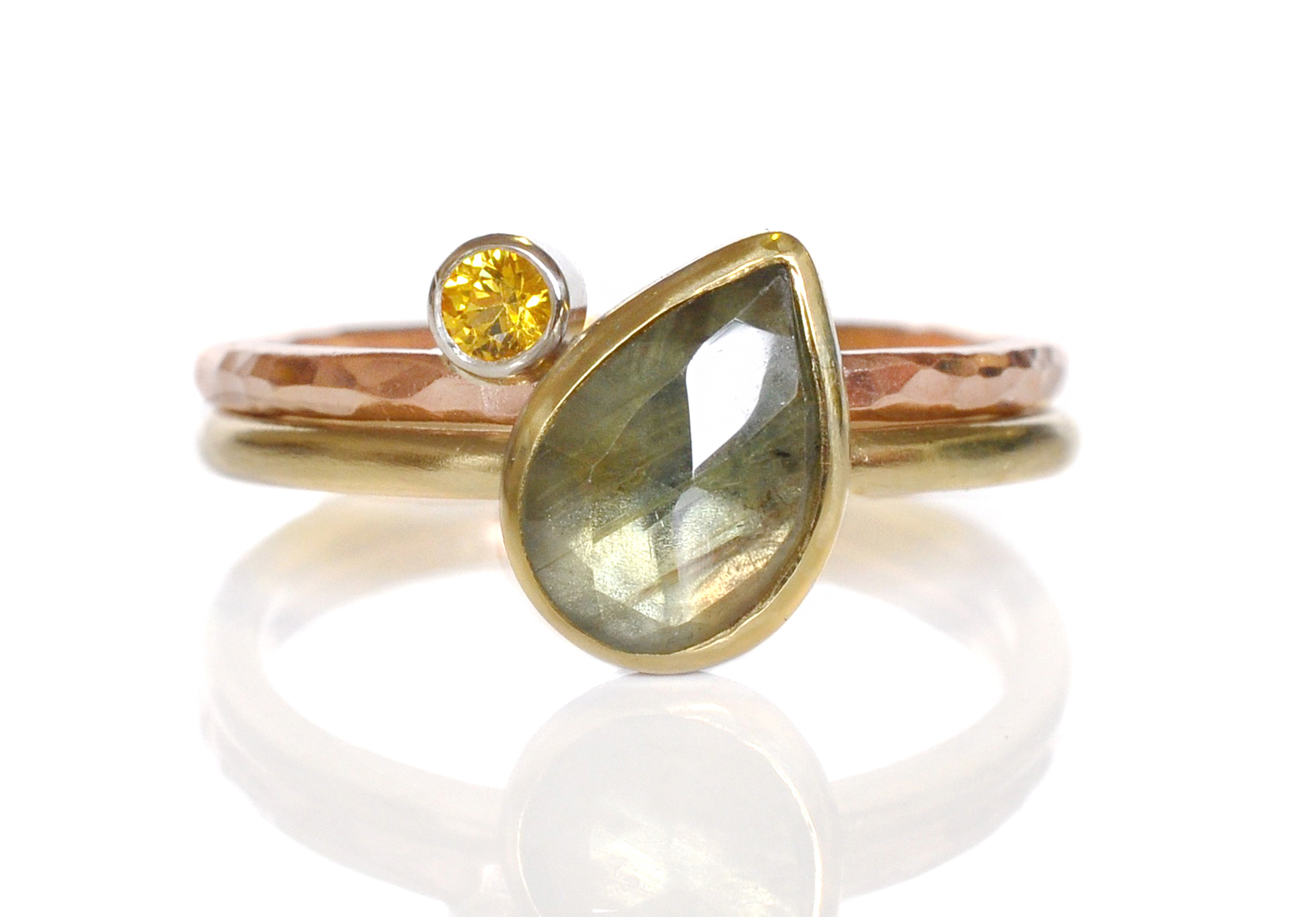 This beauty…….what can I say, Elice and Justin have great taste! I love the color combination in this stack! Green tear dropped shaped rose cut sapphire in 18k yellow gold, stacked with a sparkling yellow sapphire on a hammered 14k red gold band. I love how the yellow sapphire picks up the golden tones in the green sapphire.
