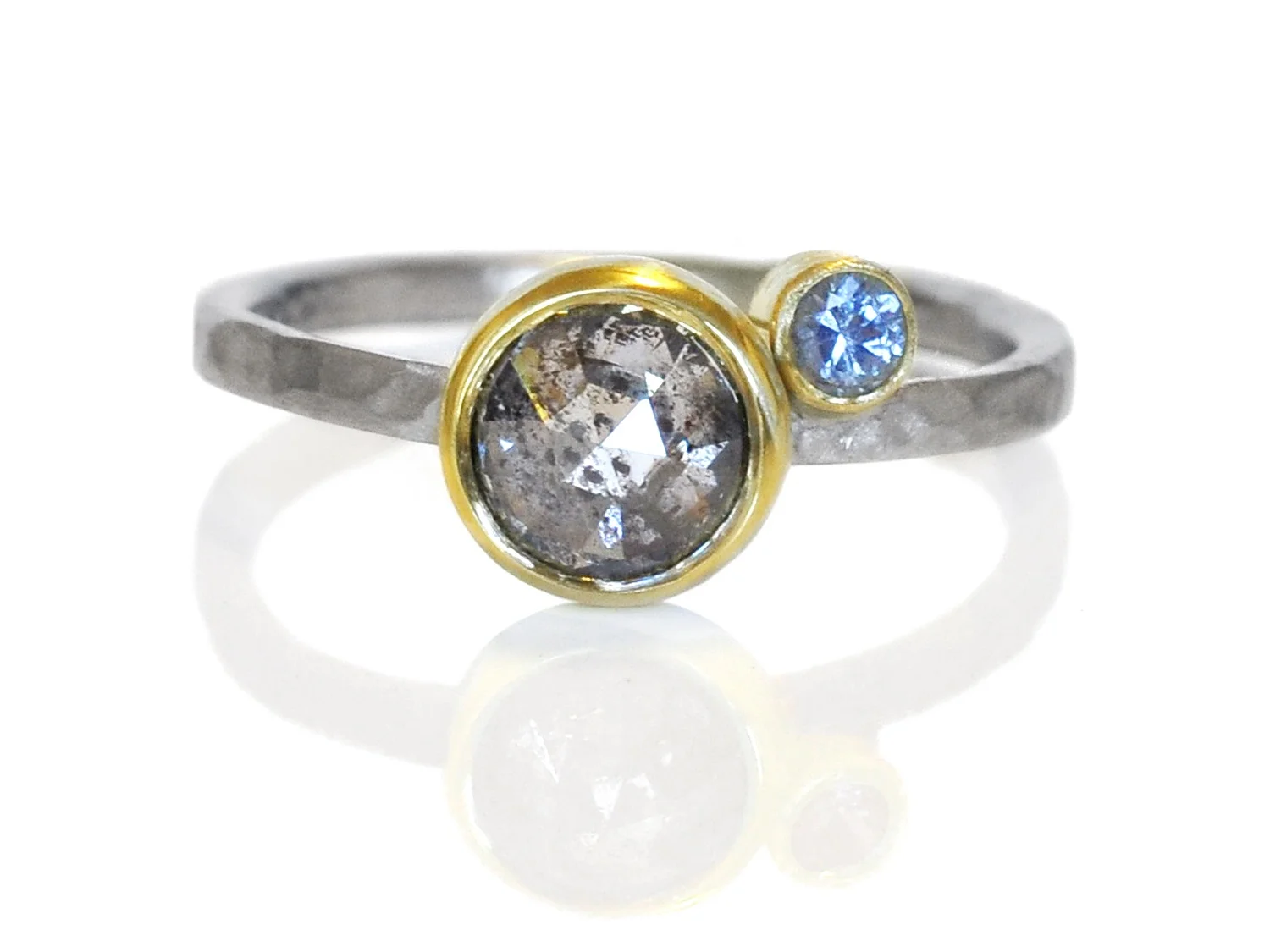Congratulations Ari and Zuzanna! I love the little bright blue sapphire buddy as compliment to the amazing universe of sparkling inclusions inside this salt and pepper diamond.