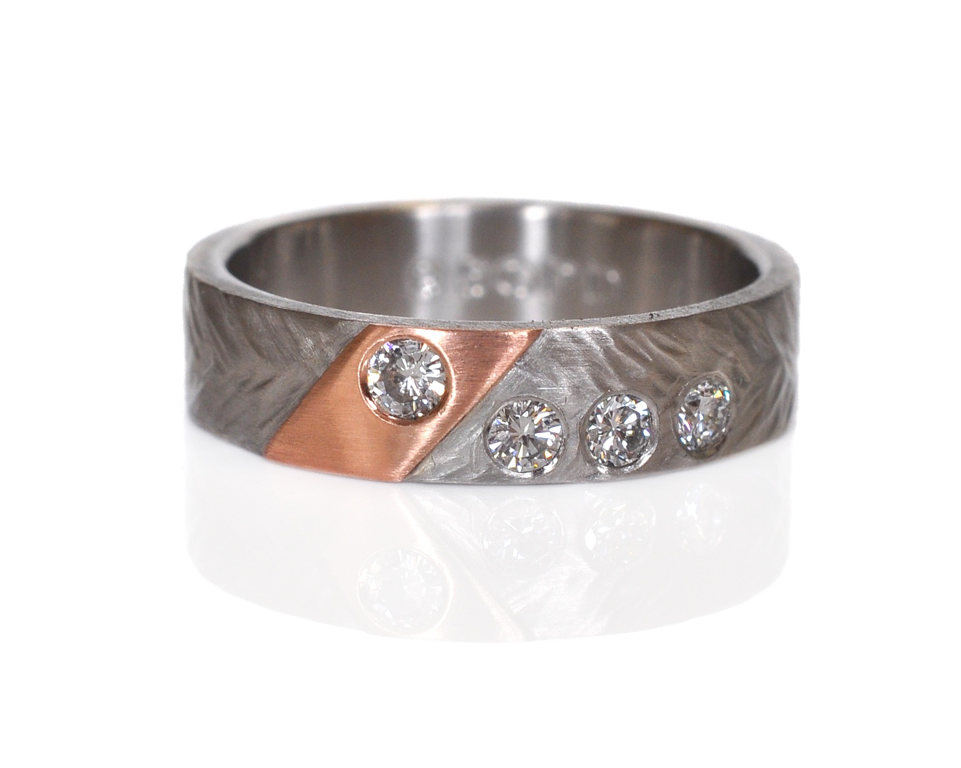 Kelly and Star had family diamonds they wanted to incorporate into Kelly’s ring and boy do they sparkle!!! Wheat hammered palladium with a 14k red gold accent and flush set diamonds. I love the asymmetry!