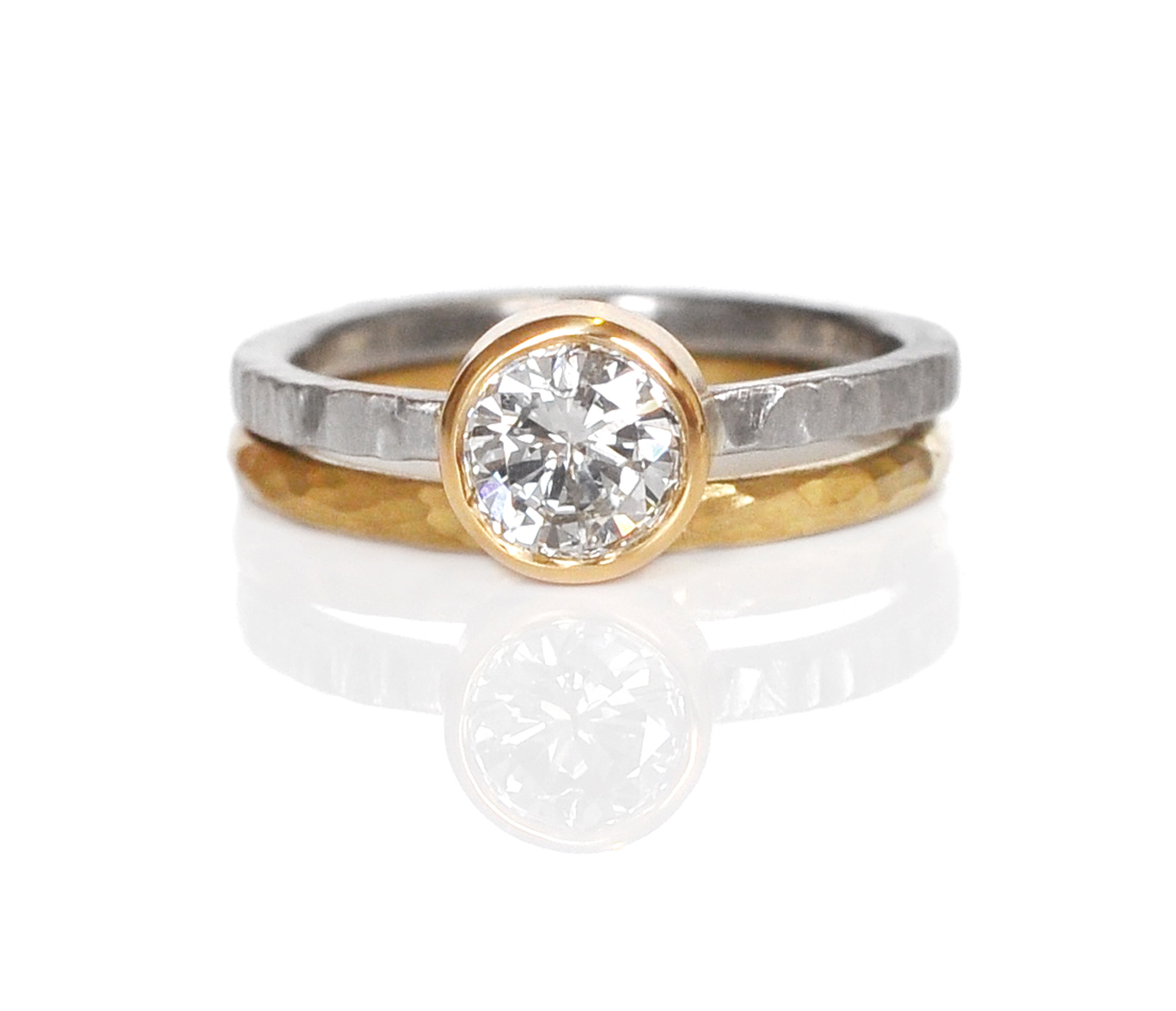 A beautiful mixed texture diamond remount for Jan! An 18k yellow gold bezel for her white diamond, set on a linear hammered palladium band and stacked with a round hammered 18k yellow gold band to bring out the bezel color.