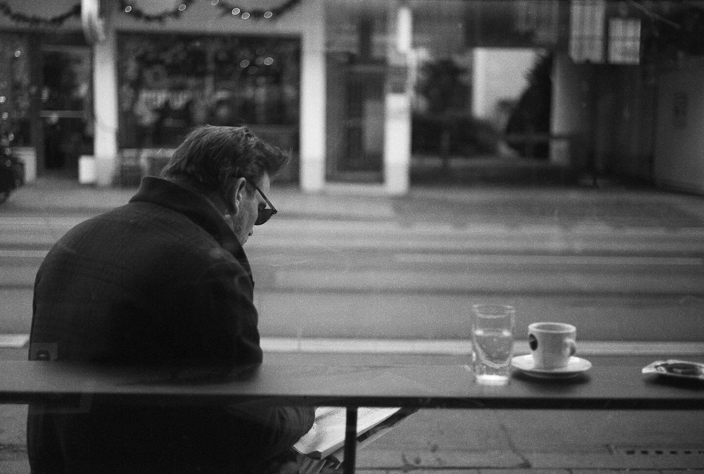 Man, coffee and newspaper. Shot on film with my Leica M6. 
The development was a bit off as the chemistry played tricks on me. But the photo could be rescued during scanning.