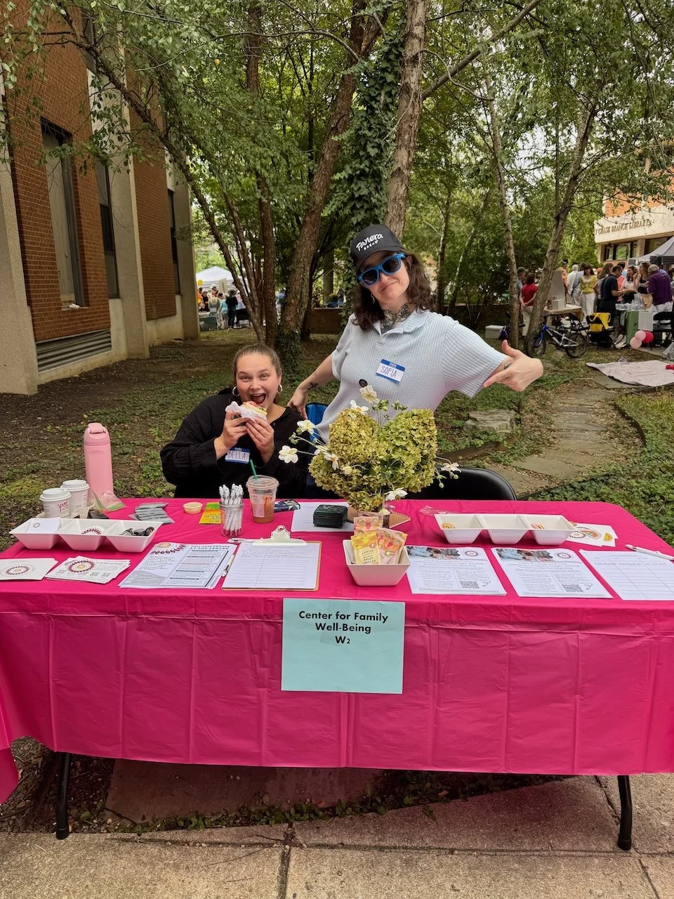 The Center's community table at Chevy Chase Day with two smiling table hosts, Bella and Sofia