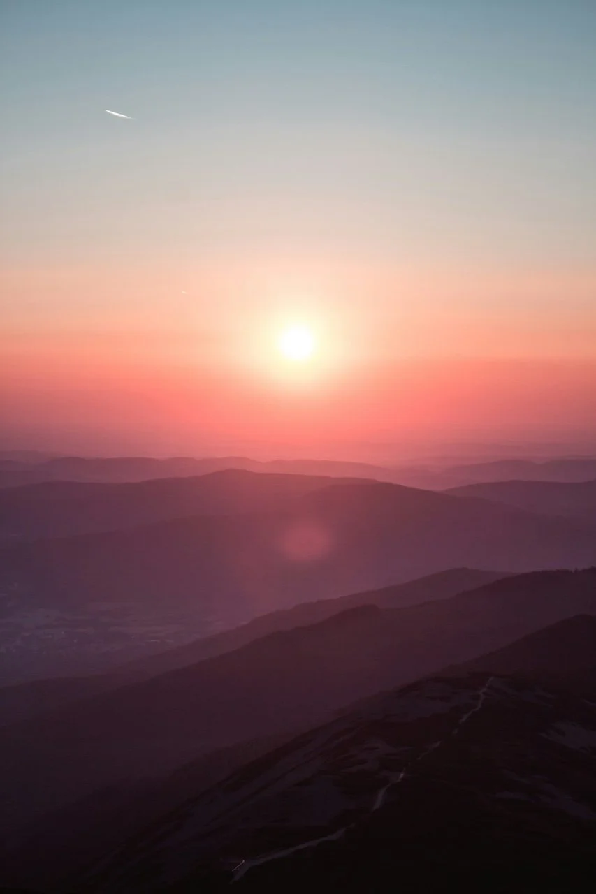Peaceful mountain sunrise with pinks and rich purples
