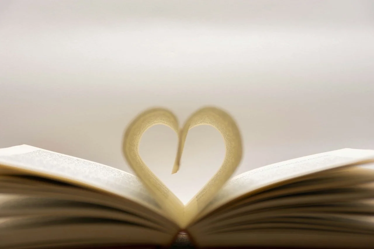 Open book, with the pages rolled into a heart shape