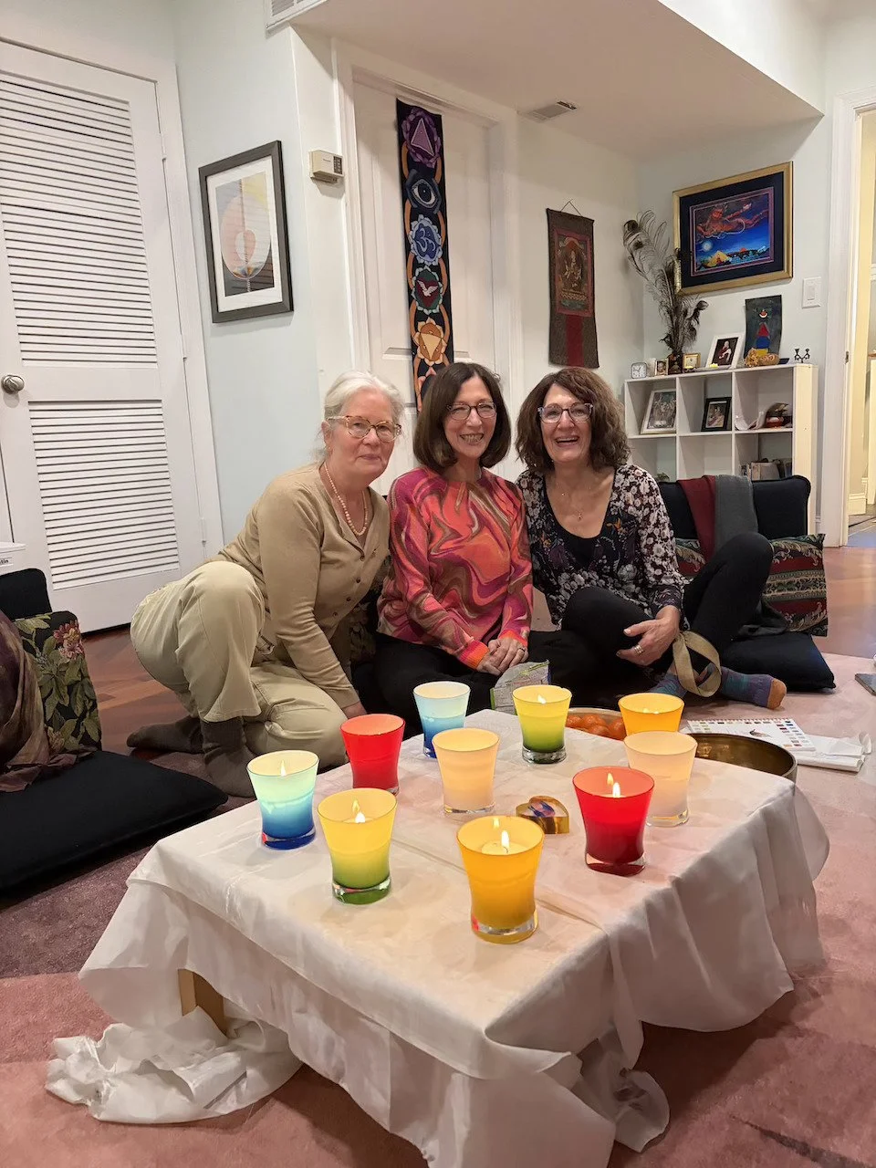 Center therapists sitting on floor smiling: Liz Hagerman and Liz Liptak, Elizabeth Ebaugh