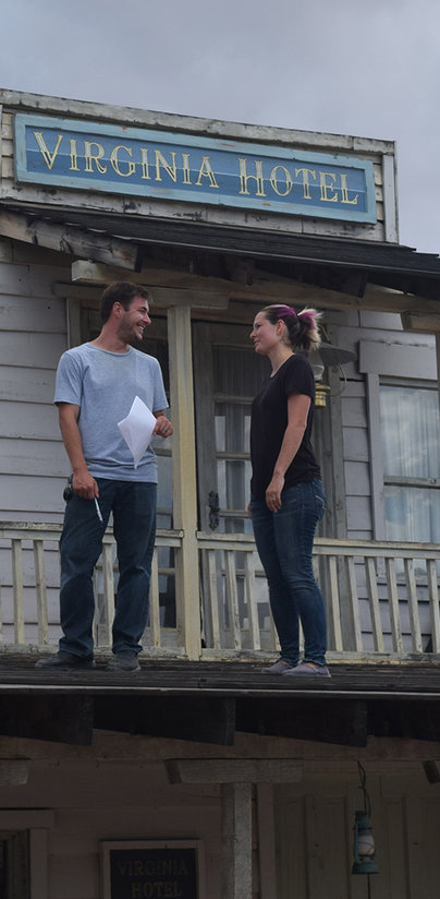 Nick and Lexie discuss a scene on a rooftop