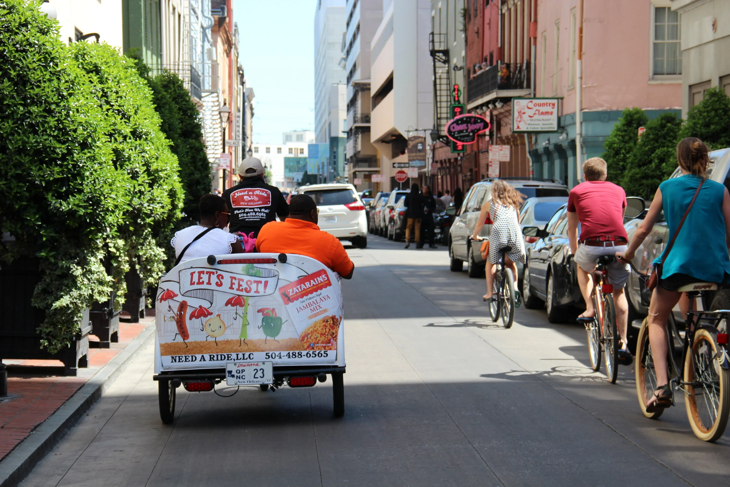 New Orleans Pedicab cruising down Iberville Street towards the Mississippi River in the French Quarter