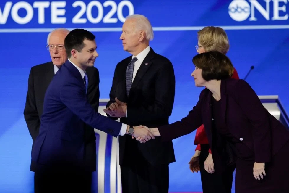 Pete Buttigieg and Senator Amy Klobuchar shake hands. AP