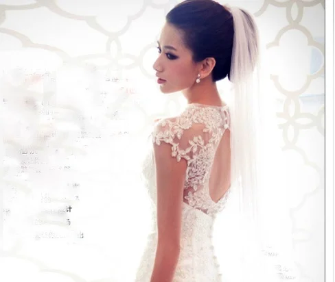  When you are standing at the altar, the guests see you from the back, so a wedding gown with an interesting back is a plus. If your gown has a back like this, choose a veil that is sheer. You want to be able to see through the veil, so you don't cov