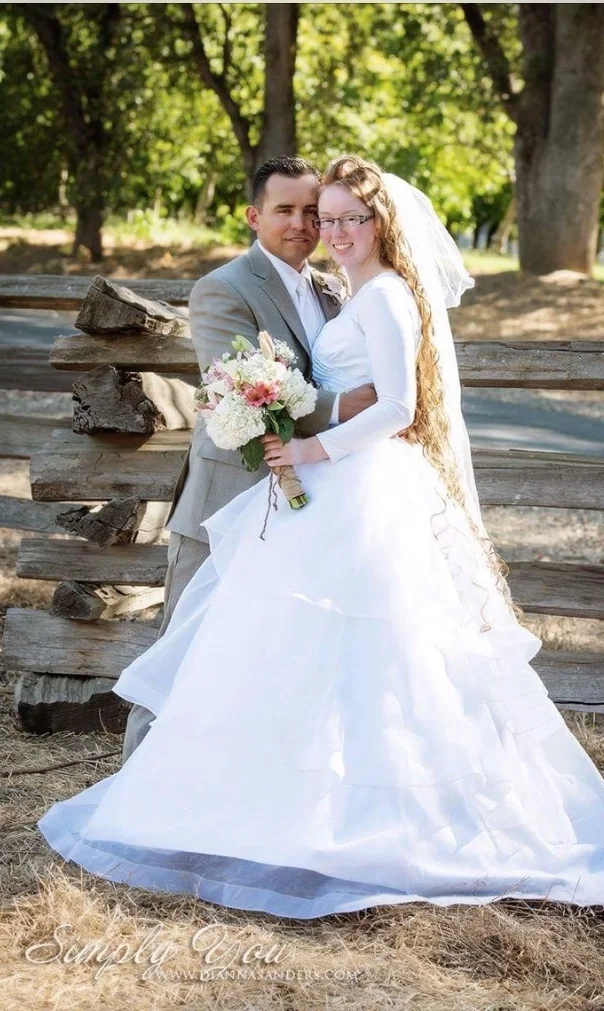  This is a ballgown with some beautiful layers that have a horsehair trim. It is a strapless. &nbsp;However,&nbsp;this bride really made it her own by adding sleeves. The veil is 4 feet long with 5 layers and has pearl beading. The veil is of course 