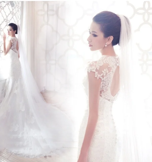  This is a mermaid style gown with a keyhole back. It has everything, satin, lace and sparkle! The train is especially pretty on this gown.&nbsp; 