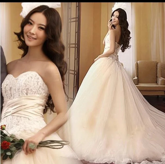  This ballgown has amazing detail. &nbsp;The bodice has a satin crisscross over beaded lace. The skirt is several layers of tulle. It is a very pale peach color. If you are having an outdoor wedding with a lot of greenery around, this is the color to