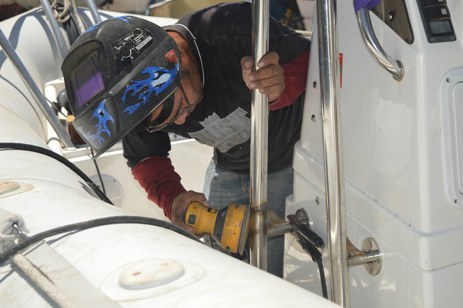 Able Pino of Berkovich Boat Works working his magic to weld the T-top on the Zodiac!