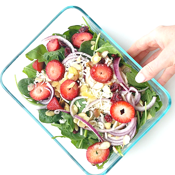Add spinach, strawberries, almonds and feta cheese in a large bowl. To make the dressing, add vinegar to a medium bowl and slowly whisk in the olive oil. Once evening coated add spices and whisk again. Drizzle the dressing on the salad and toss until evenly distributed. 