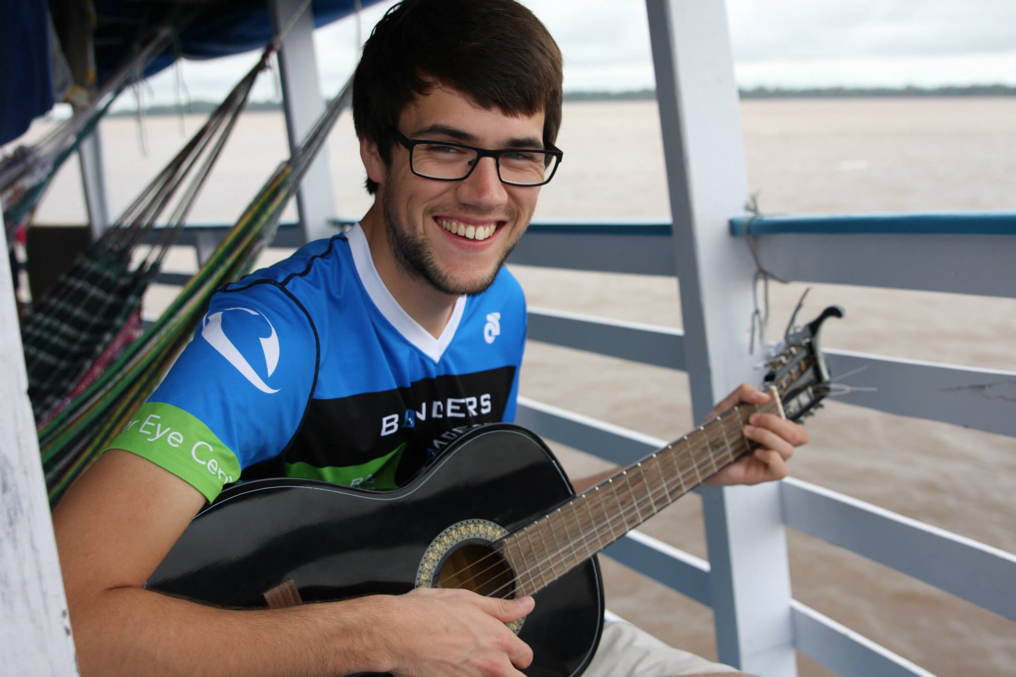 Photo By: Fernando Borges. J on the Amazon River doing some of his favourite things - ministering and music-ing