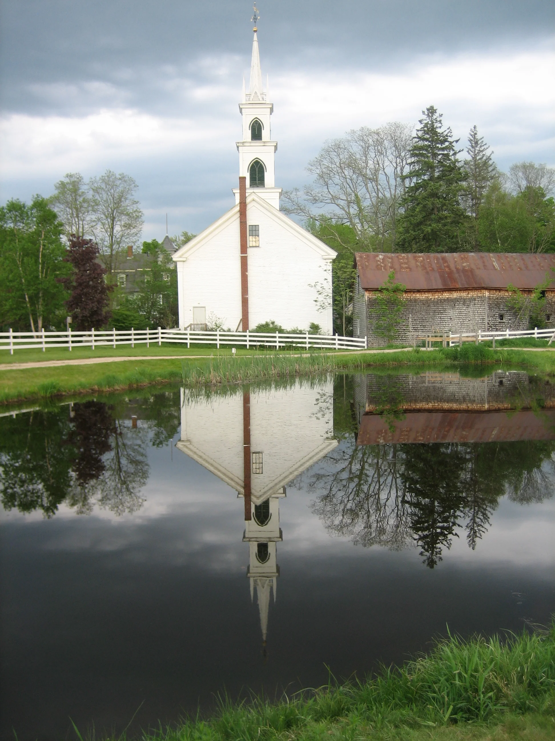 George Blanchette; The Congregational Church reflected in the Remick Museum fish pond.