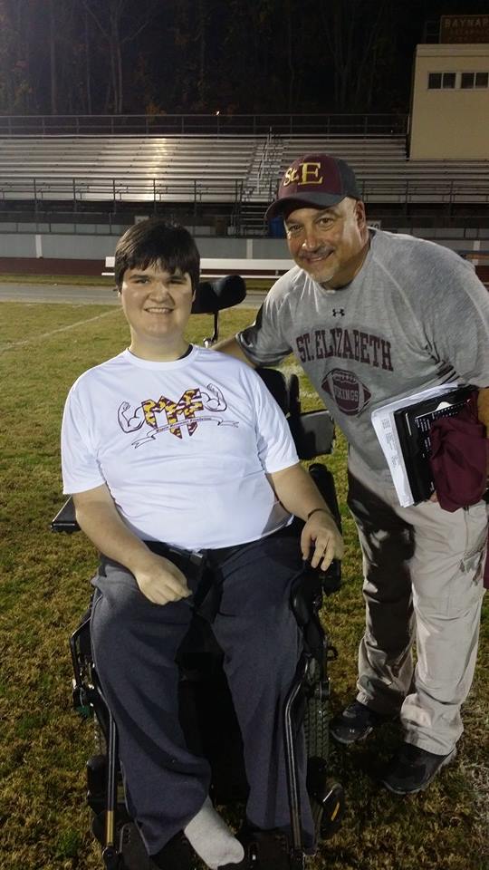 Saint Elizabeth Head Football Coach Joe Aviola with Muscle Champion Mike Smith