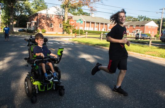 Muscle Movement Fdn. Muscle Champion, Harry Smith, and Josh Scheck race down the road! Photo Credit: EvaJo Alvarez