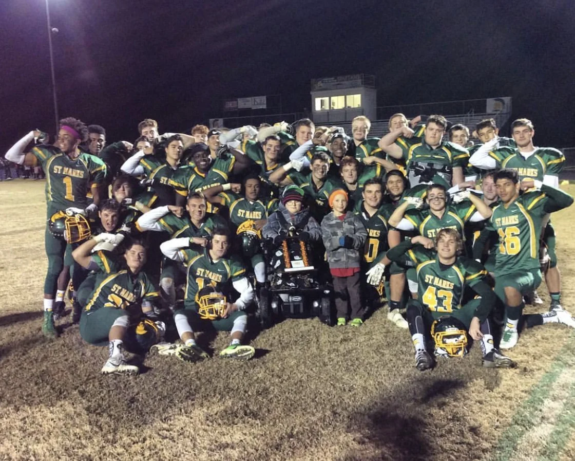Saint Mark’s Spartans (2016) celebrate with MMF Muscle Champion, Mason Nellius